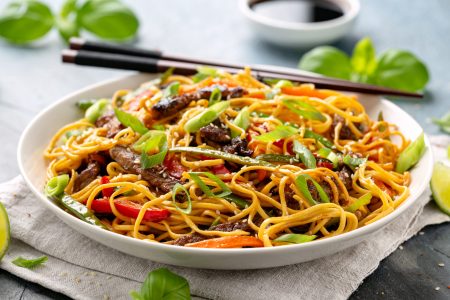 Stir fry noodles with beef and vegetable in white bowl. asian style food Stir fry noodles with beef and vegetable in white bowl. asian style food.